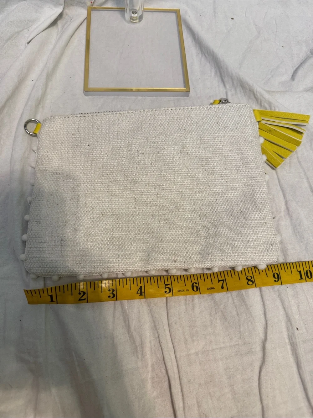 White Daisy-Embroidered Wristlet Clutch with Yellow Tassel